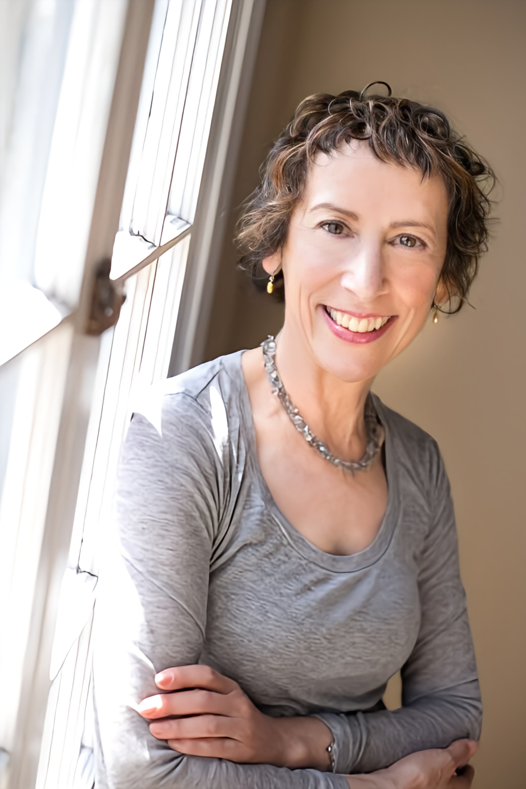 headshot of wendy braitman who is wearing a gray shirt.